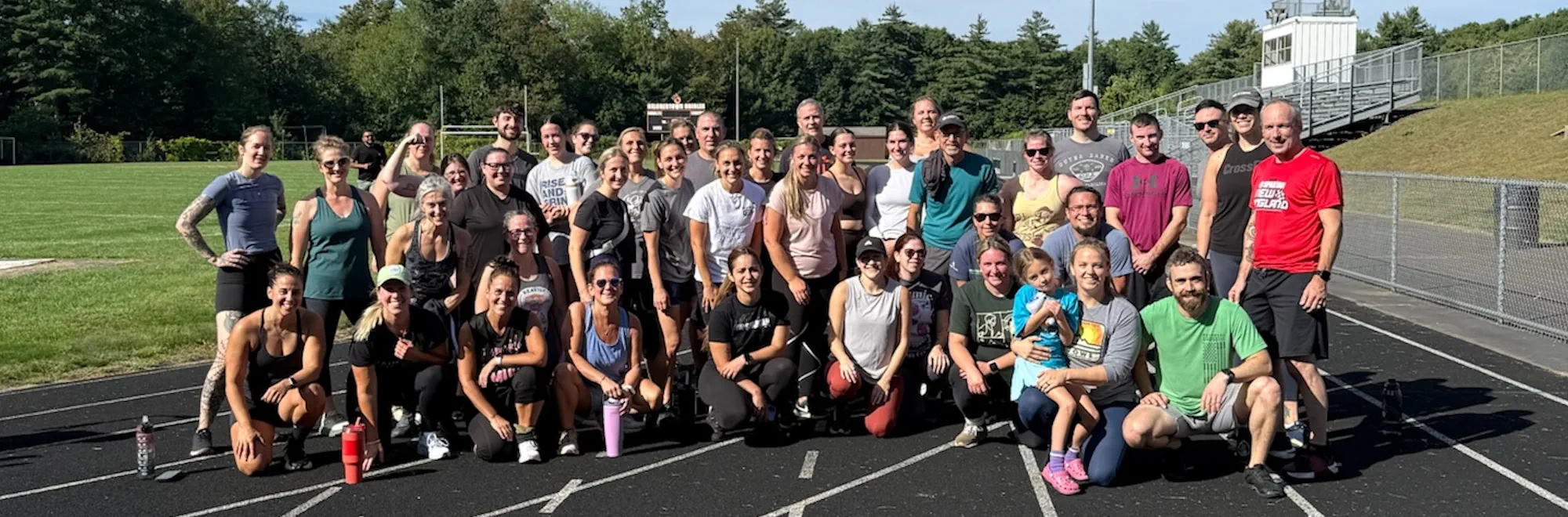 CrossFit Underpin community-workout participants gathered on a track