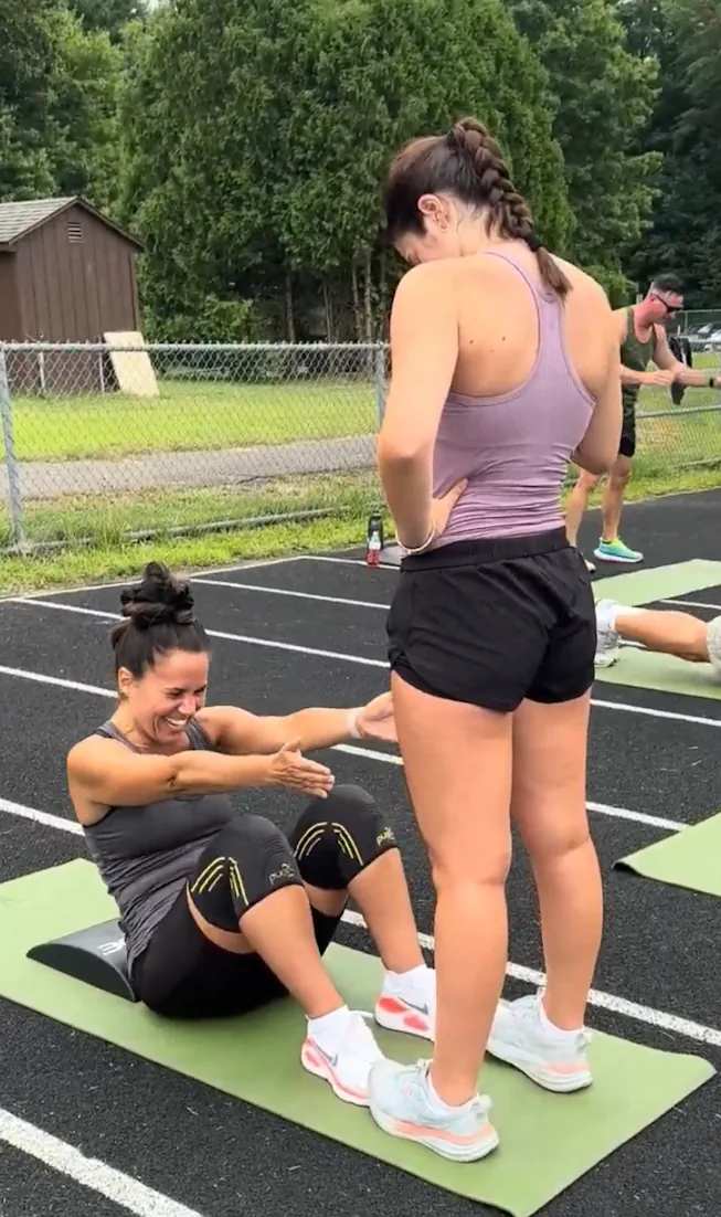 Community-workout participants completing a core exercise together
